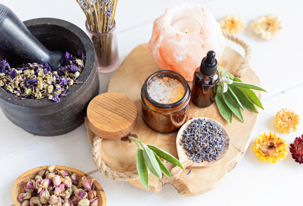 Botanical blends, herbs, essencial oils for naturopathy. Natural remedy, herbal medicine, blends for bath and tea on white wooden table background